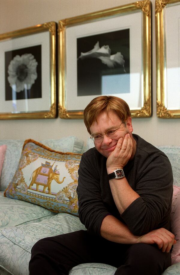 Elton John (cq) relaxes in his Atlanta condo in 2000 and discussed his photography collection. Behind him are black and white photographs by Robert Mapplethorpe. (JEAN SHIFRIN/staff)