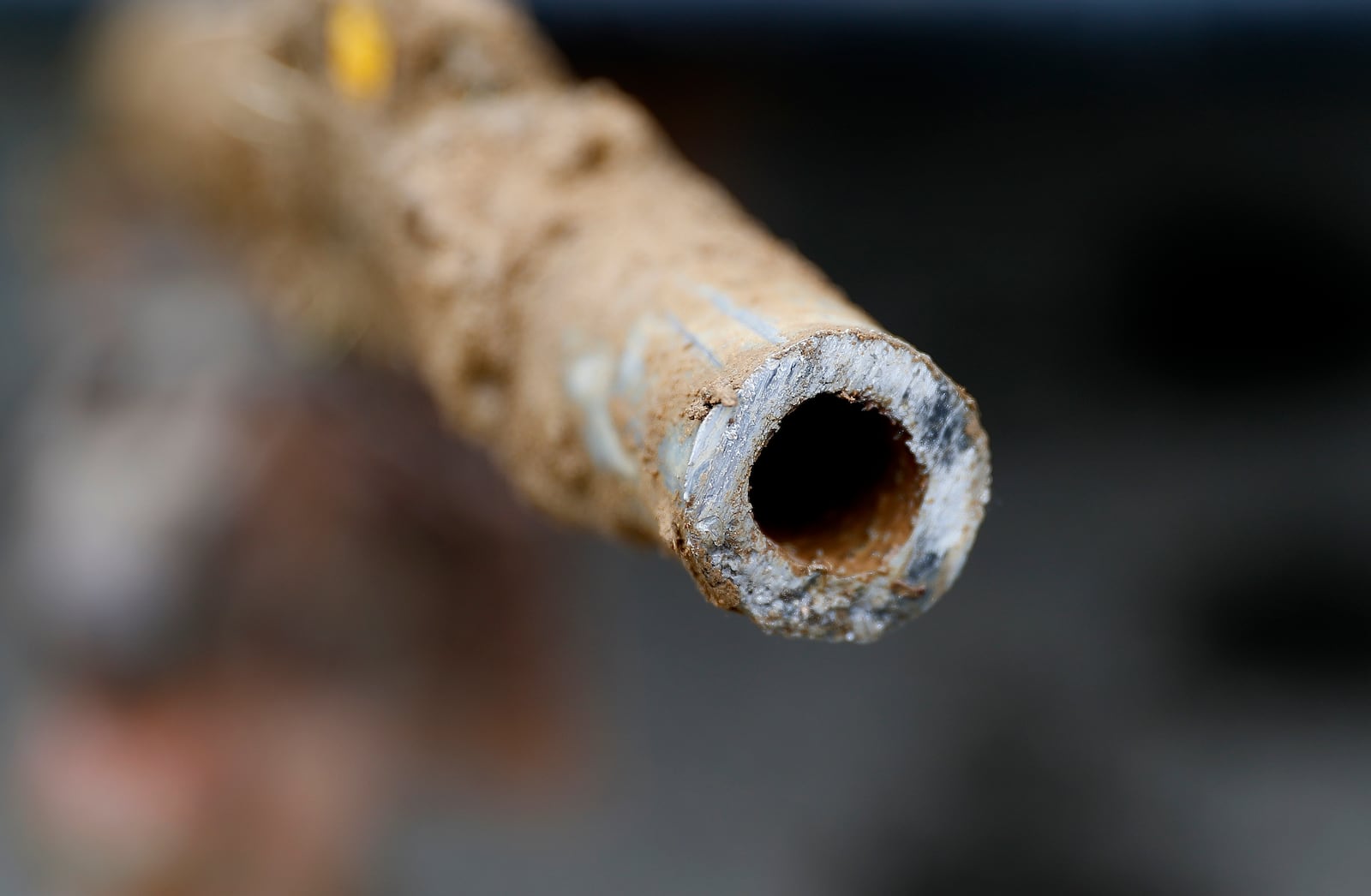 FILE - A lead pipe is shown after being replaced by a copper water supply line to a home in Flint, Mich., July 20, 2018. (AP Photo/Paul Sancya, File)