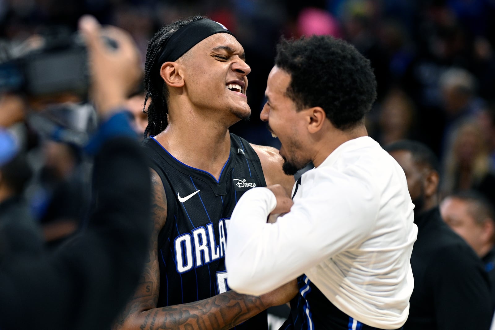 Orlando Magic forward Paolo Banchero, left, and guard Cole Anthony, right, celebrate after their win over the Indiana Pacers in an NBA basketball game, Monday, Oct. 28, 2024, in Orlando, Fla. (AP Photo/Phelan M. Ebenhack)