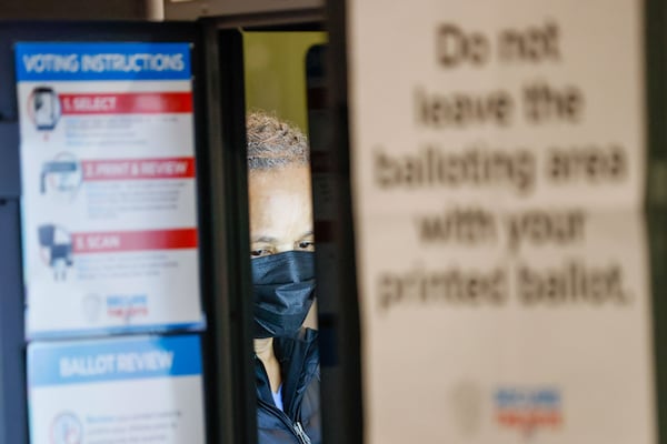 Chandra Brown casts her ballot at the Joan P. Garner Library on Ponce De Leon Avenue during the presidential primary election.