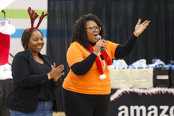 Terri-Nichelle Bradley (left), CEO and founder of Brown Toy Box, and Terreta Rodgers, the head of community engagement from Amazon's Atlanta region, surprised Humphries Elementary School students with STEAM holiday gifts last year in Atlanta. (Jason Getz/AJC 2023)