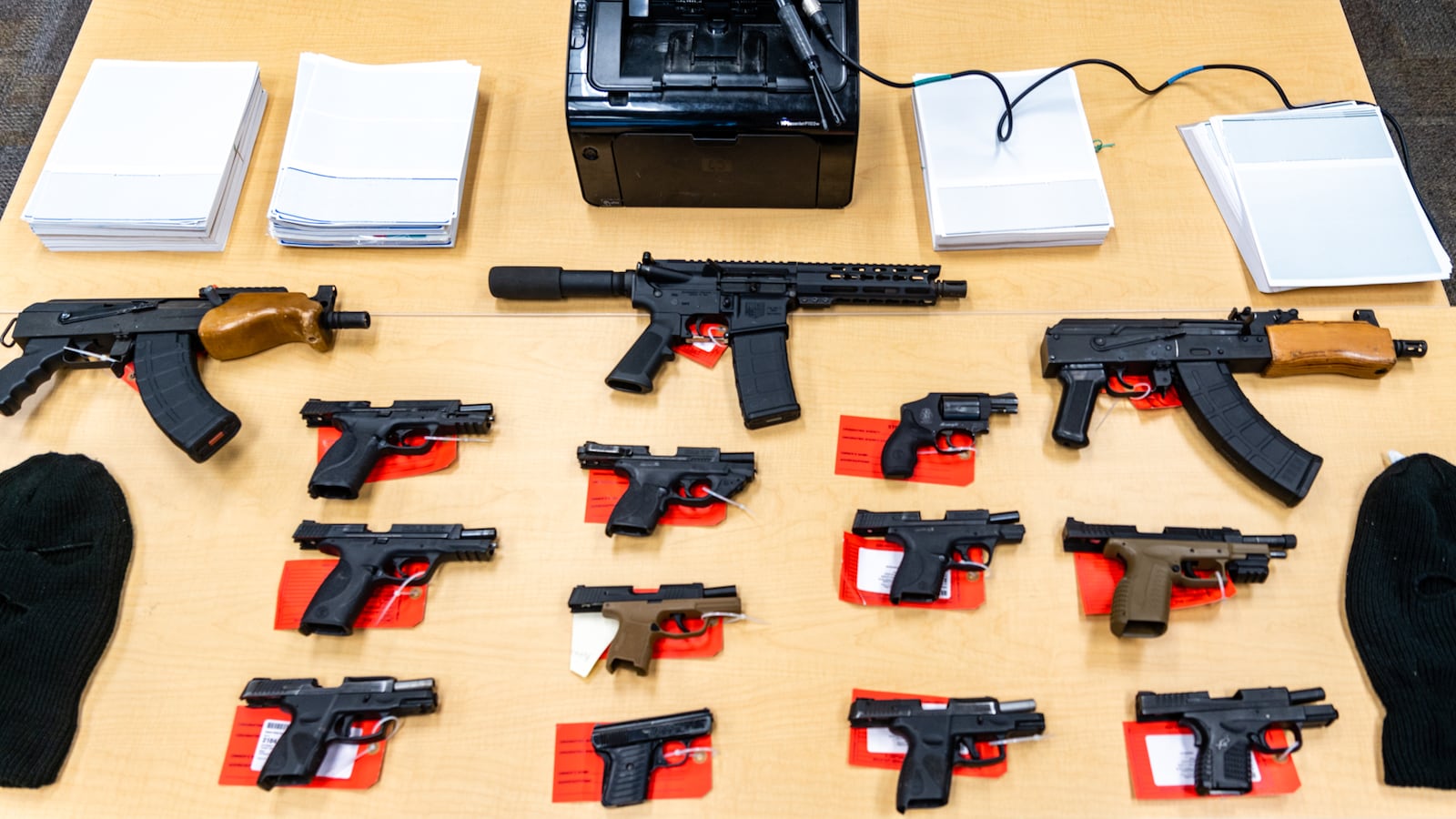 Guns, masks, a printer and reams of stock paper for printing checks were confiscated by the APD's Tactical Traffic Crime Reduction Unit in Zone 5.