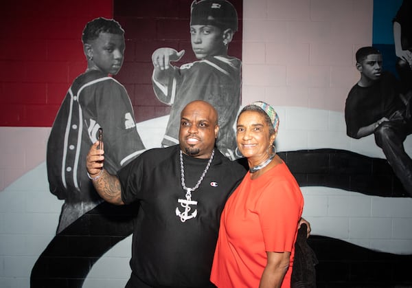 Rapper CeeLo Green and Camille Russell Love pose underneath Kris Kross’ spot on an Elevate mural celebrating Southwest Atlanta in 2018.