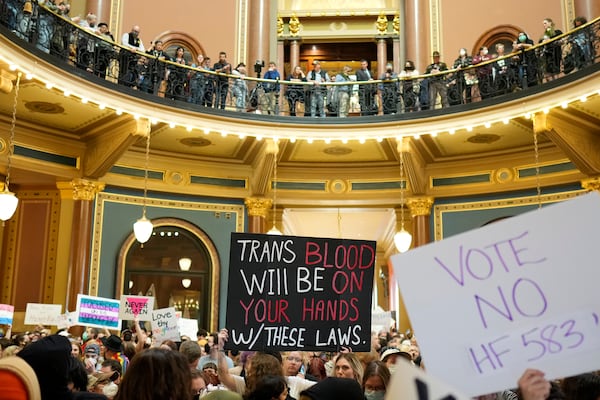 Protesters fill the Iowa state Capitol to denounce a bill that would strip the state civil rights code of protections based on gender identity, Thursday, Feb. 27, 2025, in Des Moines, Iowa. (AP Photo/Charlie Neibergall)