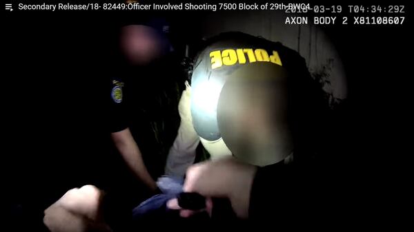 In a still image from a Sacramento police officer's body camera, fellow officers perform CPR on Stephon Clark, off camera, following his shooting the night of March 18, 2018. Clark, 23, was unarmed and carrying only a cellphone when he was shot eight times on his grandparents' back patio. His death has sparked protests in Sacramento and beyond, as well as calls for changes to the police department's use-of-force policy.