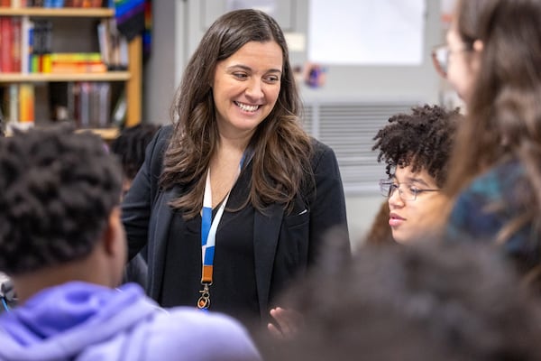 Lakeside High School teacher Lauren Lamoly walks around her college-level English composition class, helping her students with their work Tuesday, Jan. 31, 2022.  (Steve Schaefer/steve.schaefer@ajc.com)