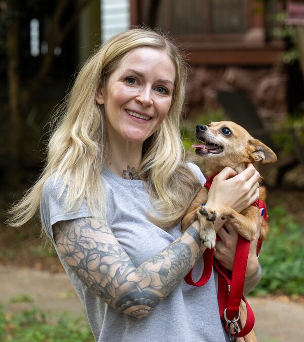 Beverly Means plays with a dog for a client in Decatur. She came up with the idea for Transitions Pet Care in 2020 when she started wondering, as a single woman with a small support system, what would happen if she ever got sick or injured and needed help caring for her pets. (Phil Skinner for the AJC)