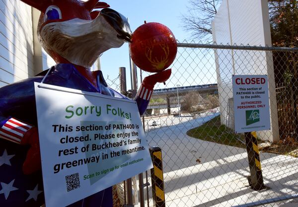 This “Closed” sign was posted at the north end of a new segment of PATH 400, near the Gordon Bynum pedestrian bridge over Ga. 400, on Dec. 19, 2019. The PATH400 through Buckhead is broken into two pieces, but this new section slated to open early next year will connect them, completing the ride through one of the busiest parts of Atlanta. New links like this are being forged in broken paths across metro Atlanta to create a regional network that could serve as an alternative to roads. HYOSUB SHIN / HYOSUB.SHIN@AJC.COM