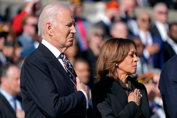 President Joe Biden, left, and Vice President Kamala Harris look on during a wreath laying ceremony at the Tomb of the Unknown Soldier on National Veterans Day Observance at Arlington National Cemetery in Arlington, Va., Monday, Nov. 11, 2024. (AP Photo/Mark Schiefelbein)