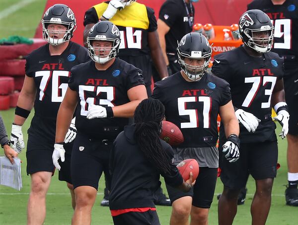 Falcons tackle Kaleb McGary (from left), guard Chris Lindstrom, center Alex Mack, and tackle Matt Gono take the line during training camp  Saturday, Aug. 15, 2020, in Flowery Branch.   