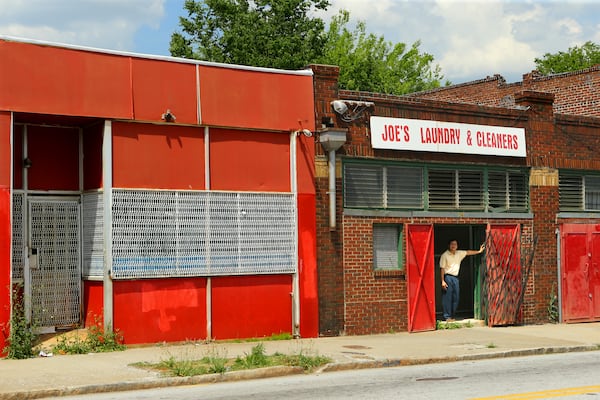 The development partners of Georgia State University said they will turn the boarded up storefronts along Georgia Avenue into a mix of shops, restaurants and a brewery/beer garden. CURTIS COMPTON / CCOMPTON@AJC.COM