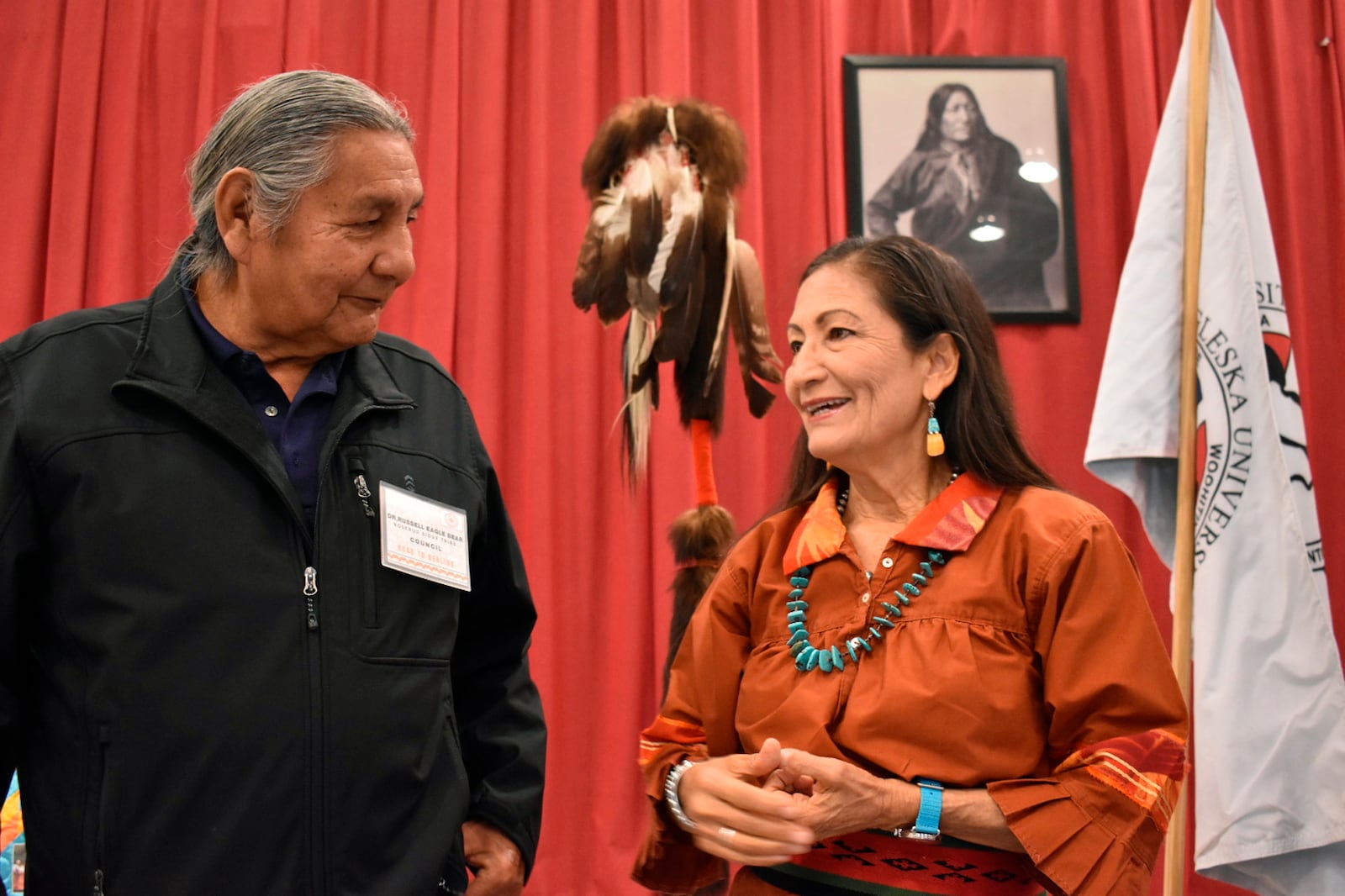 FILE - Russell Eagle Bear, with the Rosebud Sioux Reservation Tribal Council, talks to U.S. Interior Secretary Deb Haaland during a meeting about Native American boarding schools at Sinte Gleska University in Mission, S.D., on Oct. 15, 2022. (AP Photo/Matthew Brown, File)