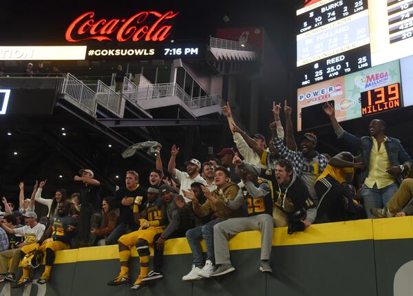 Kennesaw State University football players and students celebrate their win over Jacksonville State University at SunTrust Park, Saturday, Nov. 17, 2018, in Atlanta. Kennesaw won in overtime, 60-52. University System of Georgia students spent an estimated $4.6 billion during the 2018 fiscal year, according to a new report by the system. (Annie Rice/AJC)