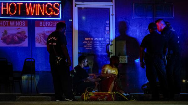 Atlanta fire crews treat a man outside a business on Metropolitan Parkway after he was shot.