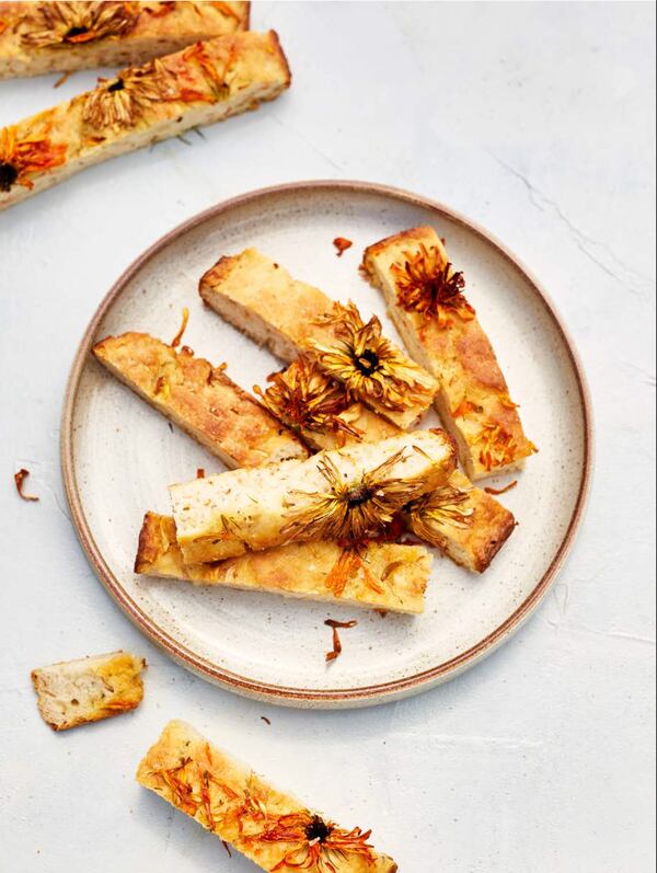 The recipe for Pot Marigold Soda Bread in “The Edible Flower” by Erin Bunting and Jo Facer (Laurence King Publishing, $40) calls for calendula petals, but those can be a little bit spicy, so you can consider substitutes. (Courtesy of Sharon Cosgrove)