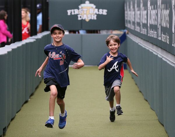 Gavi Surden (left), 10, who has autism, races his brother Noah, 6, in the first base dash at the kids friendly area of SunTrust Park while taking part in the Braves Exceptional Fans Program.Curtis Compton/ccompton@ajc.com