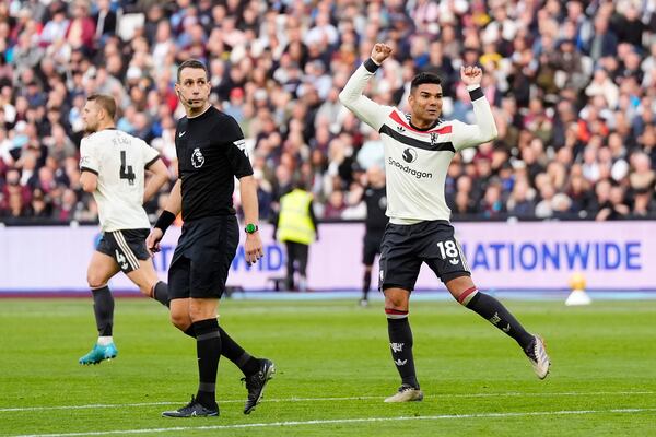 Manchester United's Casemiro celebrates scoring his side's first goal during the English Premier League soccer match between West Ham United and Manchester United at the London Stadium in London, Sunday, Oct. 27, 2024. (Nick Potts/PA via AP)