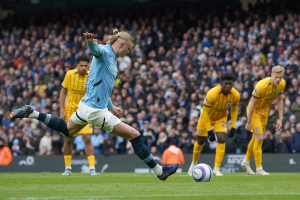 Manchester City's Erling Haaland scores his side's opening goal during the English Premier League soccer match between Manchester City and Brighton and Hove Albion at Etihad stadium in Manchester, England, Saturday, March 15, 2025. (AP Photo/Ian Hodgson)