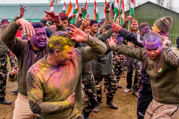 Indian security personnel from Sasastra Seema Bal (SSB) dance as they celebrate Holi inside their base camp in Srinagar, Indian controlled Kashmir, Friday, March 14, 2025. (AP Photo/Dar Yasin)