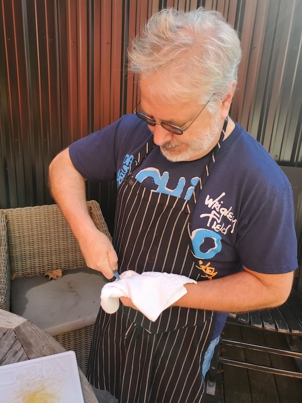 John Kessler shucks an oyster between foraging expeditions. Courtesy of Nicolas Bour