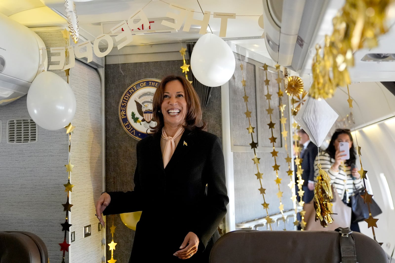 Vice President Kamala Harris is surprised by campaign staff with birthday decorations on Air Force Two before departing Atlanta on Sunday.