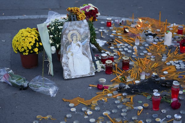 An Orthodox icon and candles for the victims after an outdoor roof collapsed at a train station in Novi Sad, Serbia, Saturday, Nov. 2, 2024. (AP Photo/Darko Vojinovic)