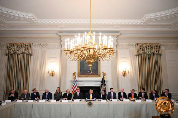 President Donald Trump, center, attends the White House Crypto Summit in Washington, Friday, March 7, 2025. (Pool via AP)