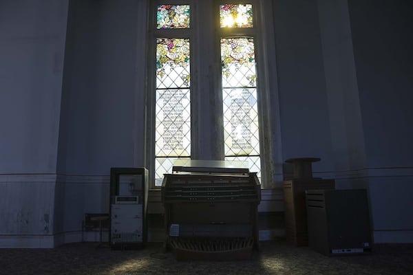 Sunlight peers through a stained glass window in the abandoned chapel space at Fountain Hall on the campus of Morris Brown College, Thursday, December 5, 2019. (ALYSSA POINTER/ALYSSA.POINTER@AJC.COM)