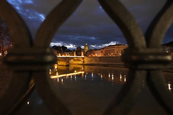 Dark clouds hover over St Peter's Basilica at the Vatican in Rome, Sunday, March 2, 2025. (AP Photo/Kirsty Wigglesworth)