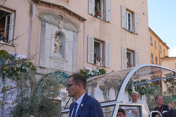 Pope Francis greets faithful after praying in for to f the statue of the Virgin Mary in Ajaccio on the occasion of his one-day visit in the French island of Corsica, Sunday, Dec. 15, 2024. (AP Photo/Alessandra Tarantino)