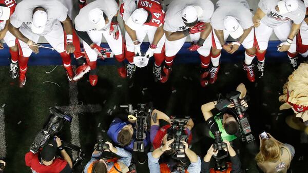  Media photographs Atlanta Falcons players after the NFL football NFC championship game between the Atlanta Falcons and the Green Bay Packers Sunday, Jan. 22, 2017, in Atlanta. The Falcons won 44-21 to advance to Super Bowl LI. John Bazemore/AP)