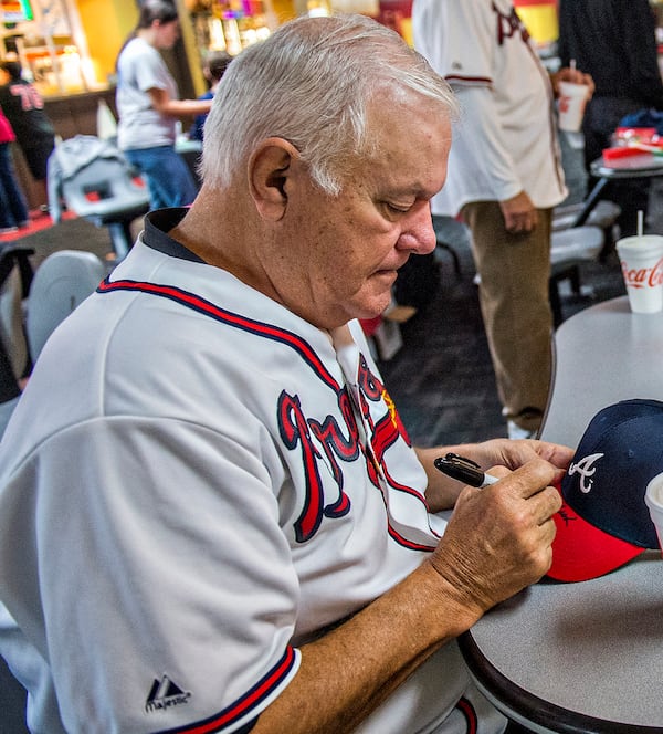 DEC. 5, 2015 — Former Braves pitcher Jim Nash signs hats for military families during the Atlanta Braves’ Military Basebowl event in Atlanta. JONATHAN PHILLIPS / SPECIAL