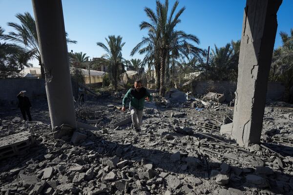 A Palestinian inspects the rubble of a destroyed building following an overnight Israeli strike in Deir al-Balah, Gaza Strip, Wednesday, Dec. 4, 2024. (AP Photo/Abdel Kareem Hana)