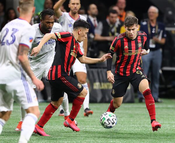 Atlanta United midfielders Ezequiel Barco (left) and Matheus Rossetto work against FC Cincinnati during a 2-1 victory Saturday, March 8, 2020, in Atlanta.   