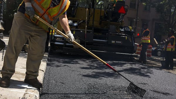 DeKalb County contractors deploy  crews to fix roads through the SPLOST paving program. AJC file photo