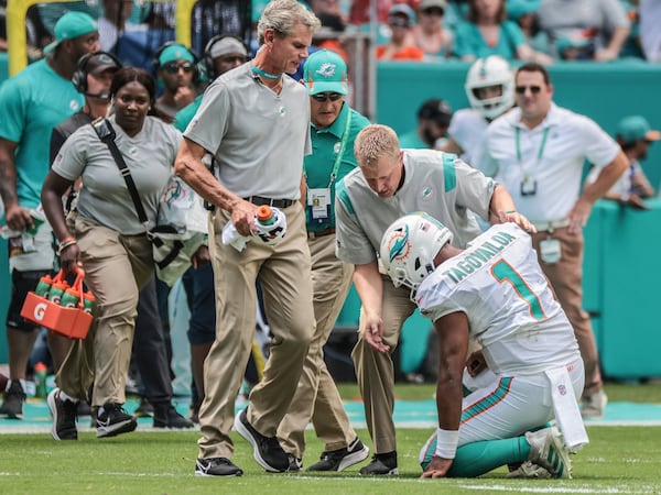 Miami Dolphins quarterback Tua Tagovailoa (1) drops to his knees after an injury suffered in the first quarter against the Buffalo Bills Sunday, Sept. 19, 2021, in Miami Gardens, Fla. (Al Diaz/Miami Herald)