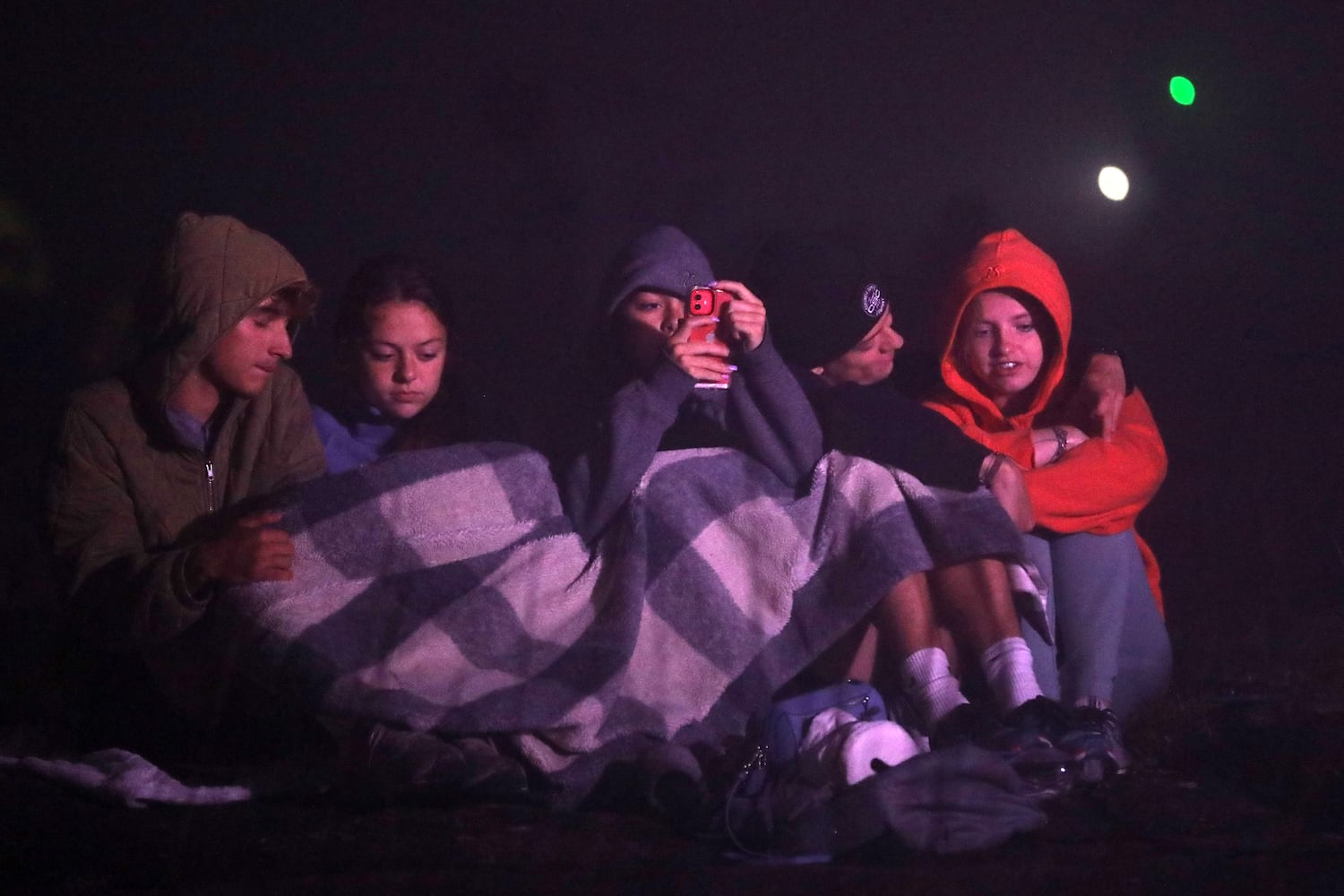 People bundle up moments before the beginning of the 76th annual Easter Sunrise Service on the top of Stone Mountain on Sunday, April 17, 2022. Miguel Martinez/miguel.martinezjimenez@ajc.com