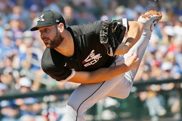 FILE - In this March 6, 2020, file photo, Chicago White Sox starter Lucas Giolito pitches in the first inning of a spring training baseball game against the Chicago Cubs in Mesa, Ariz. The White Sox arrived at spring training eyeing a jump in the AL Central and their sights set on a playoff spot. Giolito emerged as an All-Star last season, tying for the major league lead in complete games (three) and shutouts (two), after posting a major league-worst 6.13 ERA in 2018. (AP Photo/Sue Ogrocki, File)