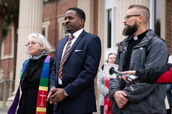 John Davis Perry II, a local minister, center, with other clergy members at Glynn County Superior Court in Brunswick, Ga., Nov. 5, 2021. The group urged the community to remain peaceful and united despite their unhappiness that a nearly all-white jury had been seated  in the trial of the white men accused of killing Ahmaud Arbery, a Black man. (Nicole Craine/The New York Times)