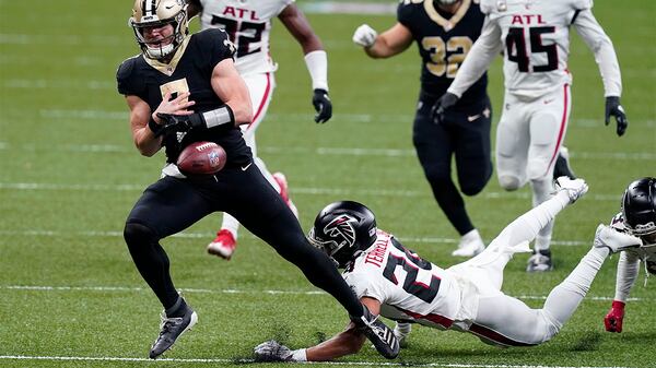 Saints quarterback Taysom Hill (7) fumbles as he is tripped up by Falcons cornerback A.J. Terrell in the second half Sunday, Nov. 22, 2020, in New Orleans. (Butch Dill/AP)