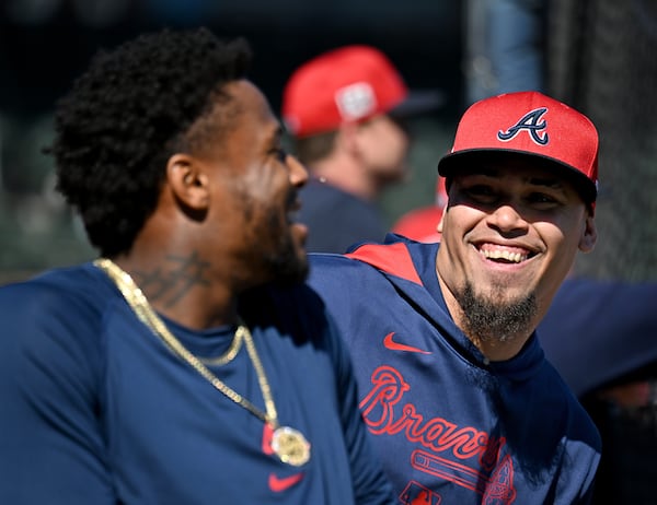 Braves shortstop Orlando Arcia (right) smiles with outfielder Ronald Acuña Jr. during Monday's spring training workouts.