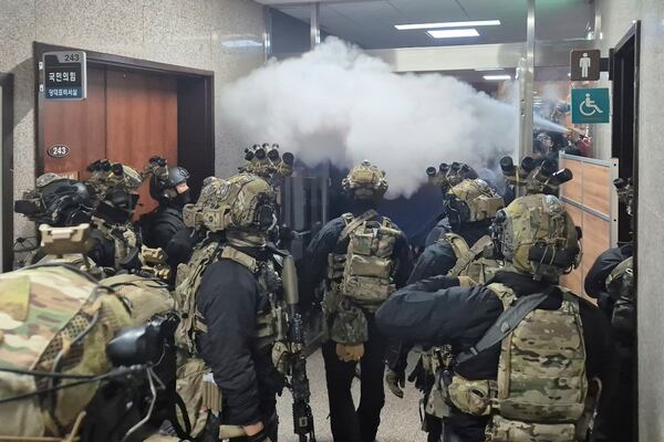 FILE - National Assembly employees spray a fire extinguisher towards soldiers at the National Assembly in Seoul, South Korea, on Dec. 4, 2024. (Cho Da-un/Yonhap via AP, File)