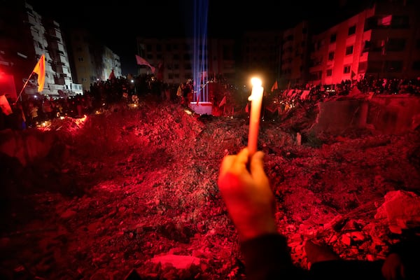 People gather at the site where former Hezbollah leader Sayyed Hassan Nasrallah was killed by Israeli airstrikes late September during a memorial ceremony in Dahiyeh, in the southern suburb of Beirut, Lebanon, Saturday, Nov. 30, 2024. (AP Photo/Hussein Malla)