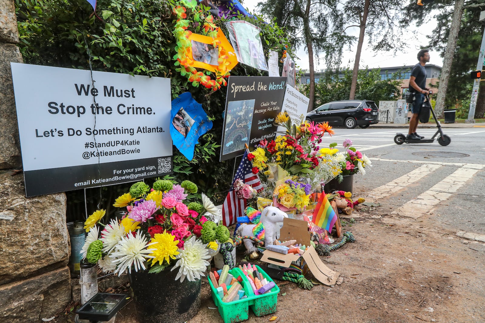 Mourners left flowers, posters and dog treats at a makeshift memorial outside Piedmont Park last summer following the high-profile killing of Katherine Janness and her dog, Bowie.
 Spink / John.Spink@ajc.com)

