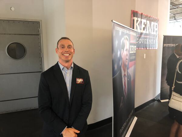 Allen Fox poses for a picture at Kemp campaign headquarters.