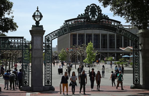 FILE - Students walk past Sather Gate on the University of California at Berkeley campus in Berkeley, Calif., May 10, 2018. (AP Photo/Ben Margot, File)