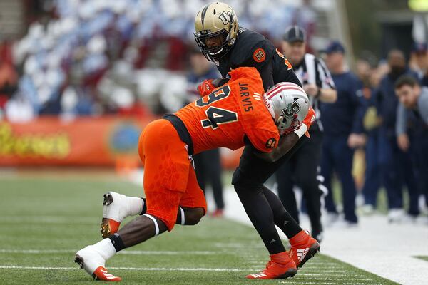 Jordan Akins #88 of the South team is tackled by Dewey Jarvis #94 of the North team during the first half of the Reese's Senior Bowl at Ladd-Peebles Stadium on January 27, 2018 in Mobile, Alabama.  (Photo by Jonathan Bachman/Getty Images)