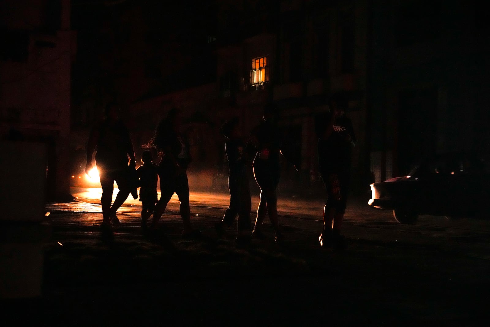 Residents walk on a street during a blackout following the failure of a major power plant in Havana, Cuba, Sunday, Oct. 20, 2024. (AP Photo/Ramon Espinosa)