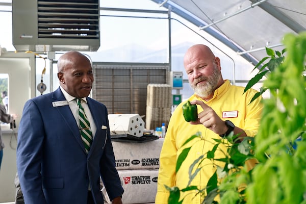 Gwinnett County Public Schools Superintendent Calvin Watts chats with STEM coordinator Eric Stoker in Archer High School’s greenhouse on Thursday, Sept. 1, 2022. (Natrice Miller/natrice.miller@ajc.com)