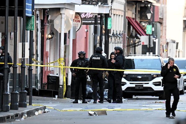 Several law enforcement agencies investigate on Bourbon Street, where a vehicle drove into a crowd and killed at least 15 people early Wednesday in the French Quarter of New Orleans.